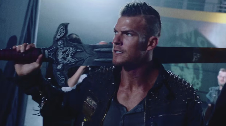 Alan Ritchson's Arthur Bailey is seen in closeup holding a weapon in Blood Drive