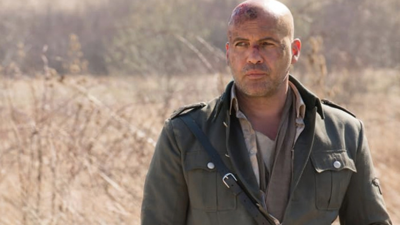 Billy Zane as Dr. Engel stands in a field in Ghosts of War