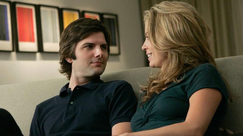 Palek and Carolyn looking at each other on a couch in Tell Me You Love Me