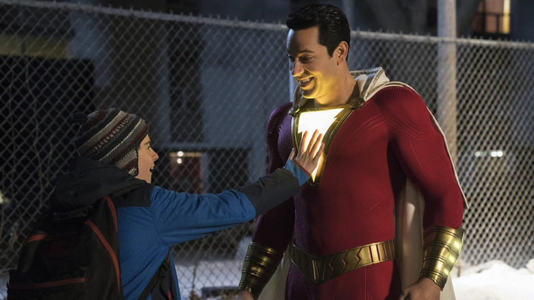 Shazam -- Freddy and Shazam standing in the dark, with Freddy touching the lit up lightning bolt on Shazam's chest
