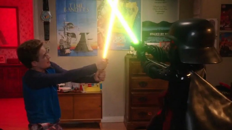 Sean Giambrone as Adam Goldberg does battle with Rick Moranis as Dark Helmet in The Goldbergs