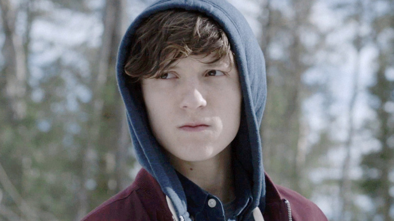 Bradley wearing a blue hoodie in a snowy forest in Edge of Winter