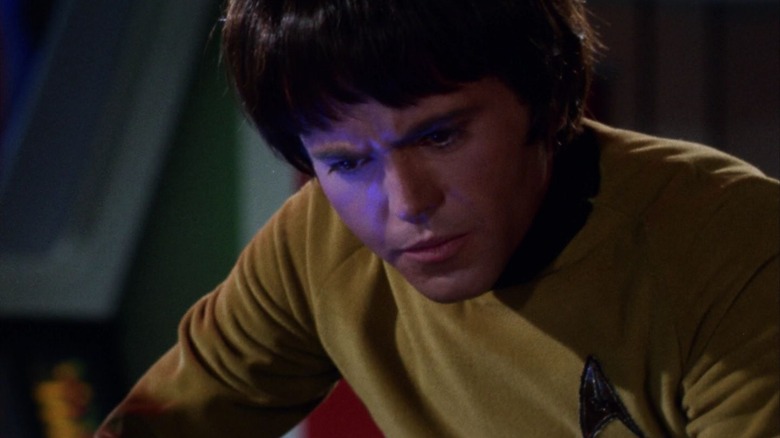 Chekov looking intense, with purple light on half of his face, on Star Trek
