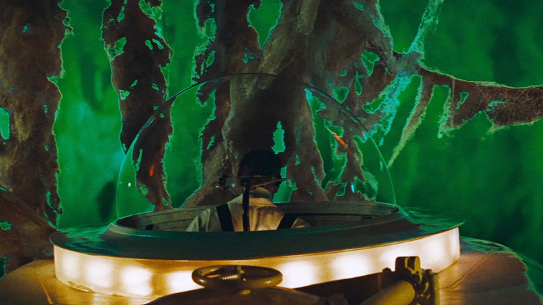 A miniaturized scientist looking around the green interior of a human body in Fantastic Voyage