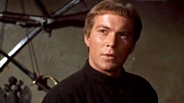 Alexey in front of some weapons in The Brothers Karamazov