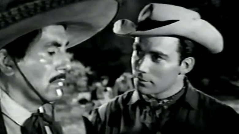 William Shatner as Wayne Gorham stands next to Rico Alaniz as Captain of Rurales in Outlaws