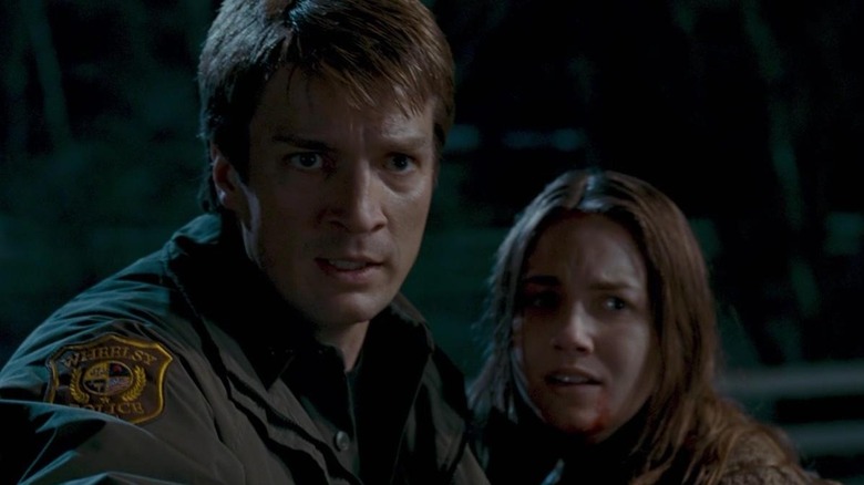 Nathan Fillion as Sheriff Bill Pardy and Tania Saulnier as Kylie in Slither