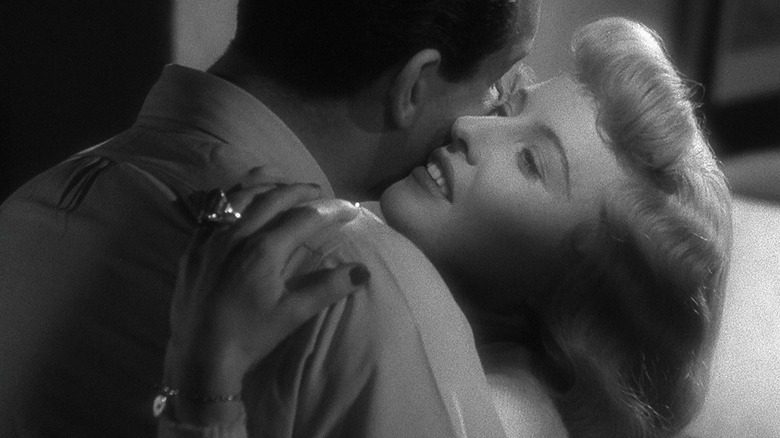 Phyllis hugging Walter deviously in Double Indemnity