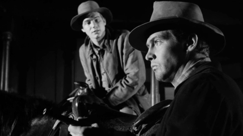 Lee Majors' Dave Lukens prepares his pistol as Sheldon Allman Cory's Lukens watches in Gunsmoke.jpg.jpg
