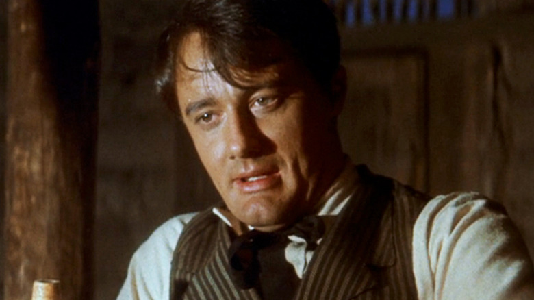 Robert Vaughn's Lee is seen in closeup looking disheveled in The Magnificent Seven