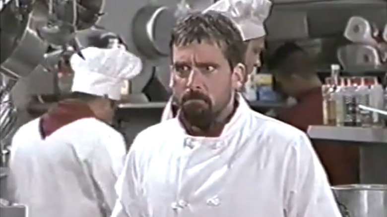 Steve Carell's Yorgo Galfanikos looks upset as he stands in a hotel kitchen in Over the Top