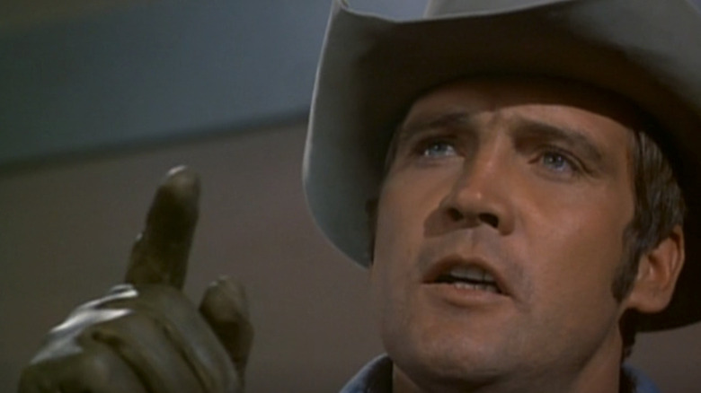 Lee Majors' Joe Briggs raises his hand in Alias Smith and Jones