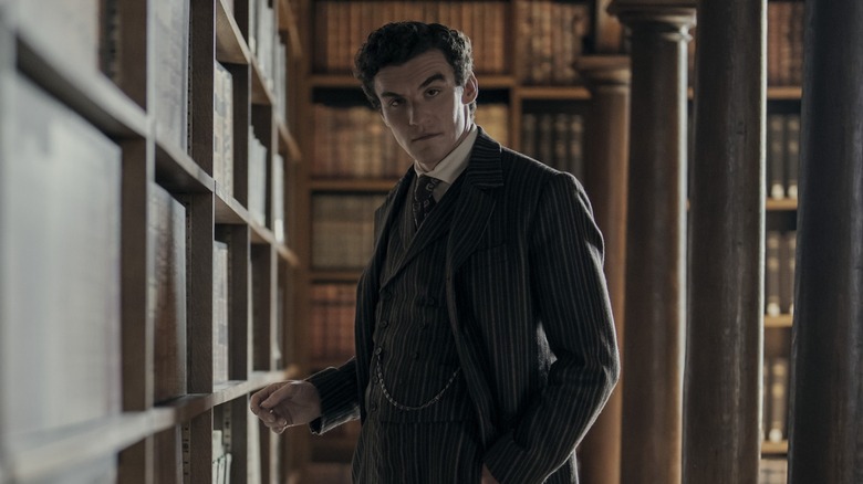 Dónal Finn looks devilishly handsome browsing a library as James Moriarty in Young Sherlock