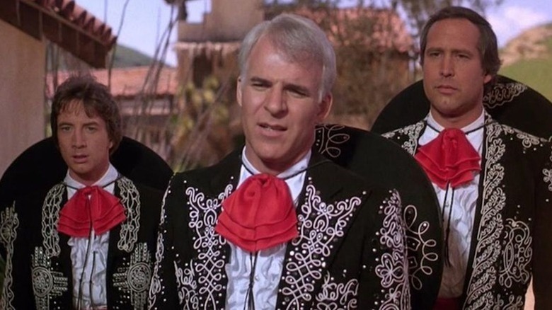 Ned Nederlander (Martin Short), Lucky Day (Steve Martin), and Dusty Bottoms (Chevy Chase) stand wearing their mariachi outfits in Three Amigos