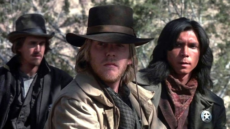 Steve Stephens (Dermot Mulroney), Doc Scurlock (Kiefer Sutherland), and Jose Chavez y Chavez (Lou Diamond Phillips) stand warily in Young Guns