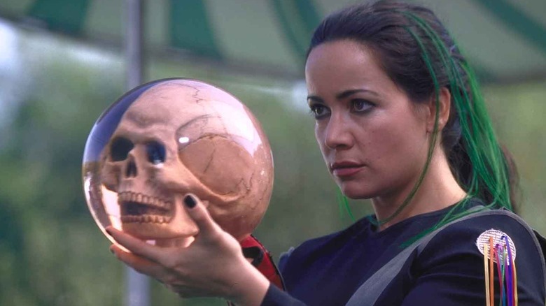 The Bowler stands with her skull bowling ball