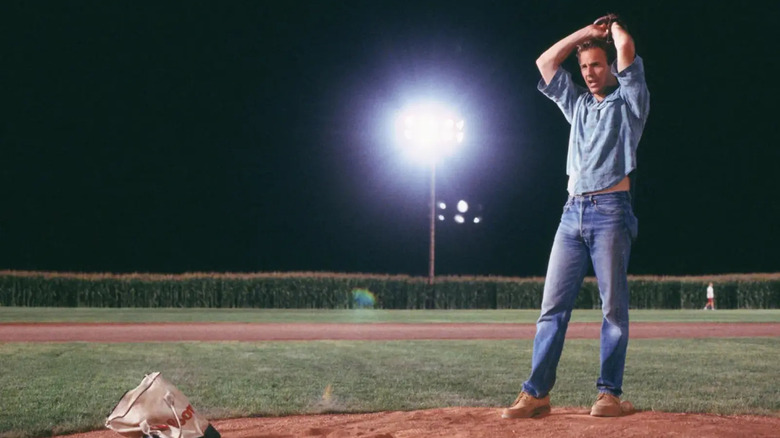 Ray about to pitch a baseball at night in Field of Dreams.