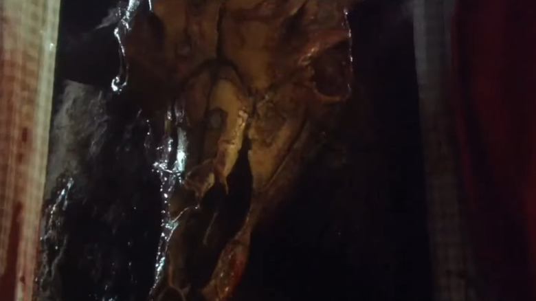 A horse skull is pushed through a window on the feast of the movie