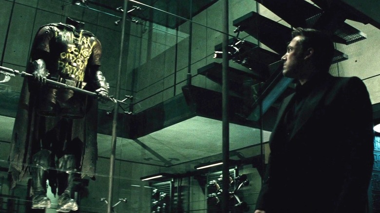 Batman v Superman - Bruce Wayne looking at Robin's defaced costume in the Batcave