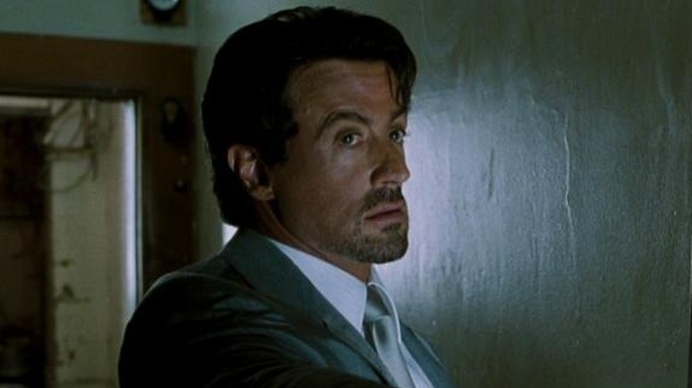 Sylvester Stallone as Jack Carter holding his gun out in front of him in Get Carter (2000)