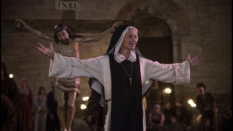 Benedetta in front of a crucifix