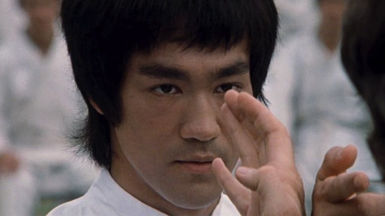 Bruce Lee as Lee, facing off against an opponent in Enter the Dragon