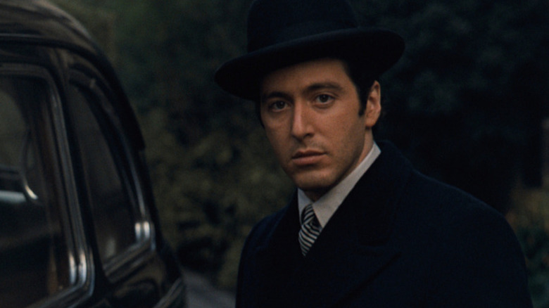 Michael Corleone standing by car in The Godfather