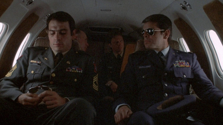 Johnny Vohden (Tommy Lee Jones) and Charles Rane (William Devane) sit next to each other in a private plane in Rolling Thunder