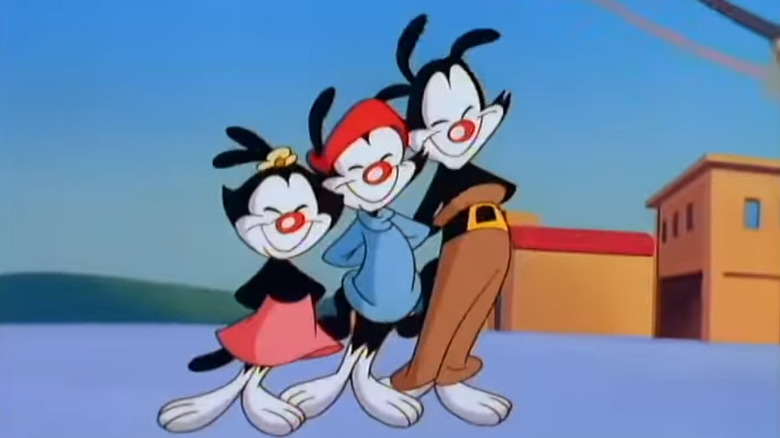 Animaniacs smiling with hands in air