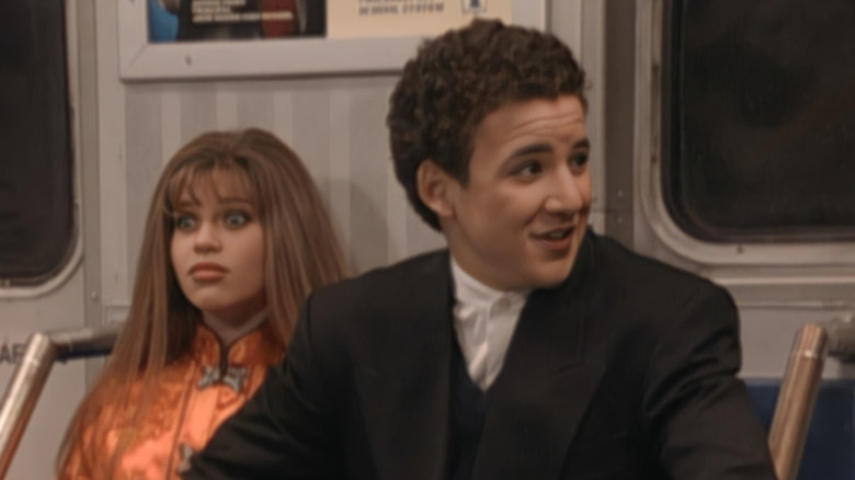 Topanga Lawrence (Danielle Fishel) and Cory Matthews (Ben Savage) look uncomfortable on the subway in Boy Meets World