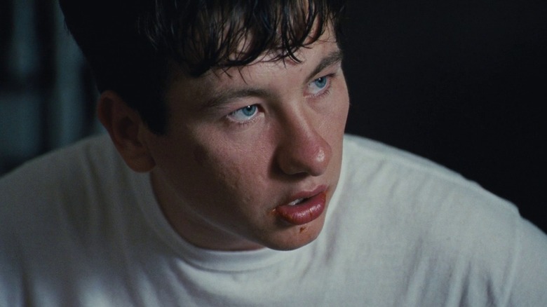 Barry Keoghan as Martin in The Killing of a Sacred Deer, lip bloody, staring in anger