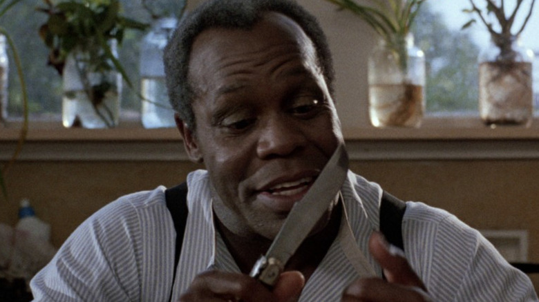 Danny Glover as Harry playing with knives in To Sleep With Anger
