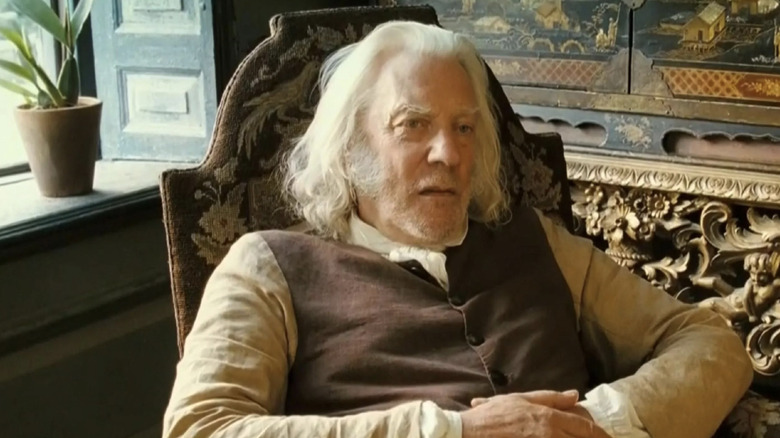 Donald Sutherland as Mr. Bennet sitting in a chair in Pride & Prejudice