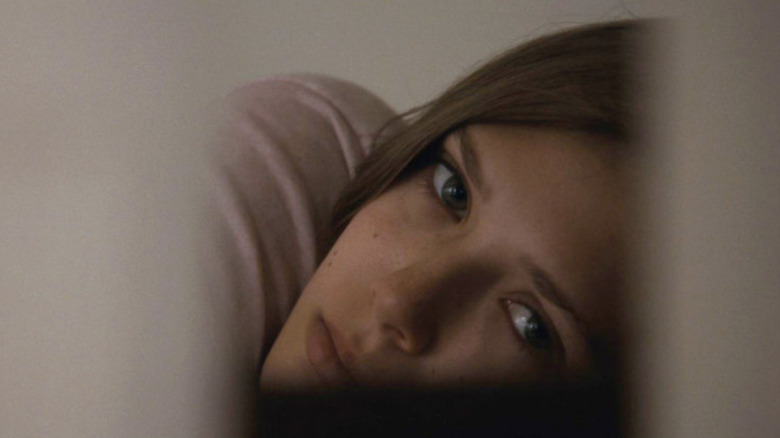 Elizabeth Olsen as Martha laying down in Martha Marcy May Marlene