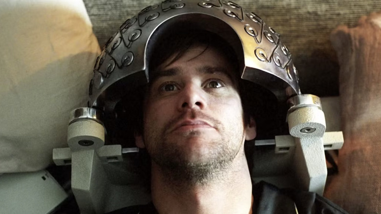Jim Carrey as Joel Barish in bed a neural device on his head in Eternal Sunshine of the Spotless Mind