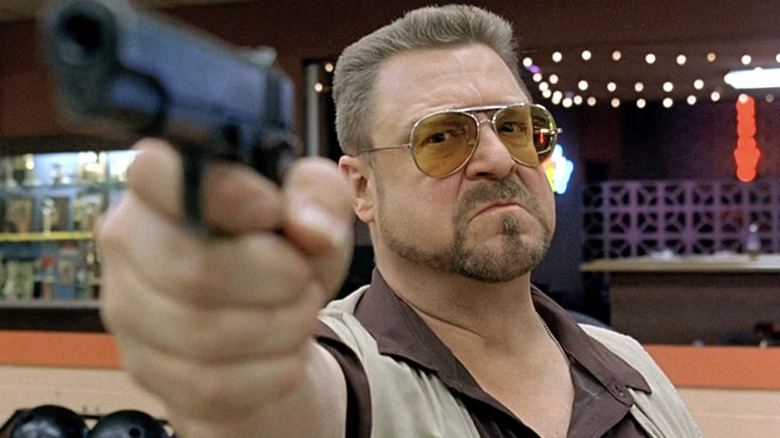 John Goodman as Walter Sobchak pointing a gun in The Big Lebowski