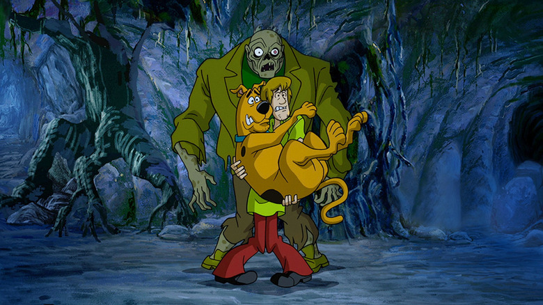 Shaggy and Scooby, voiced by Billy West and Scott Innes, scared of a zombie in Scooby Doo on Zombie Island