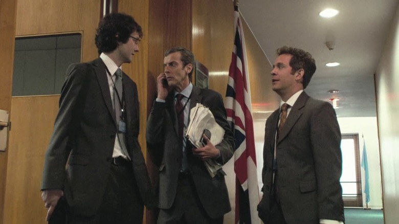 Chris Addison as Toby Wright, Peter Capaldi as Malcolm Tucker, and Tom Hollander as Simon Foster MP having a discussion in In the Loop