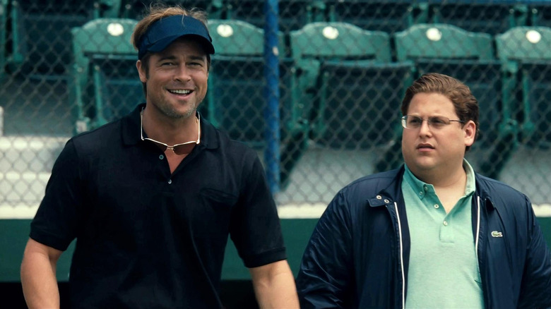 Billy Beane (Brad Pitt) laughs on the baseball field along side Peter Brad (Jonah Hill) in Moneyball