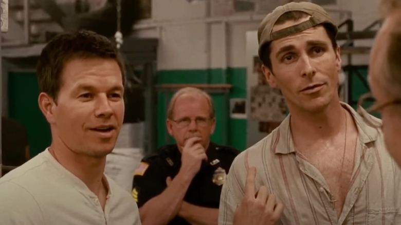 Mark Wahlberg as Micky Ward stands next to Christian Bale in The Fighter