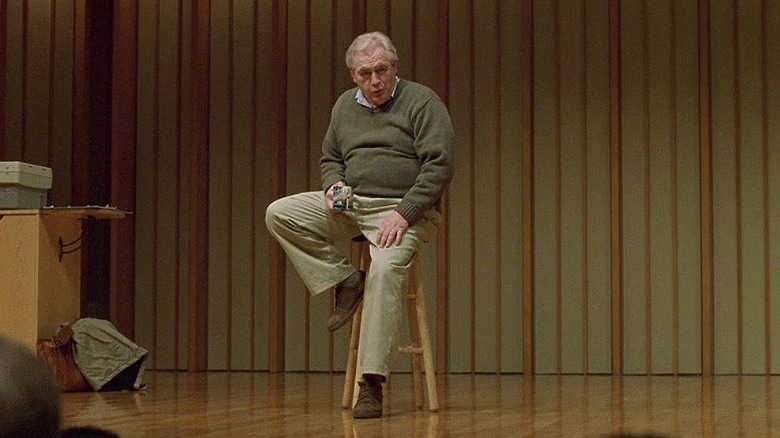 Brian Cox sits in "Adaptation"