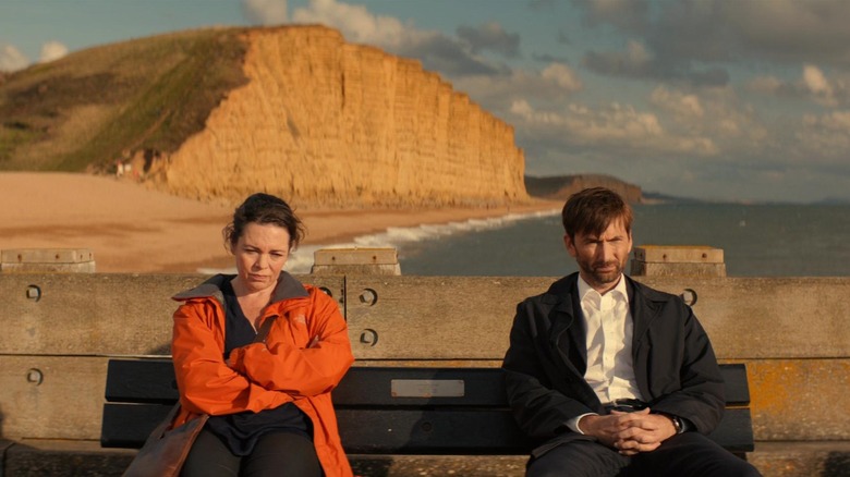 Olivia Colman and David Tennant as Ellie and Alec sitting on a bench in Broadchurch
