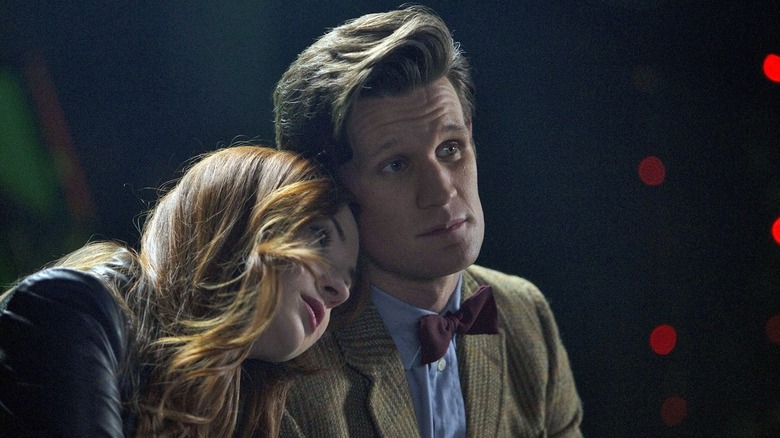 Karen Gillan as Amy Pond leaning on Matt Smith as The Doctor's shoulders in Doctor Who