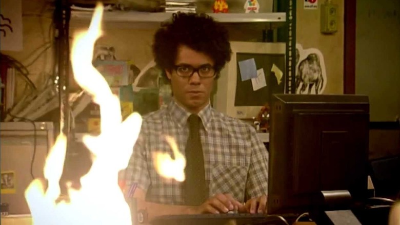 Richard Ayoade as Maurice staring at a fire in The IT Crowd