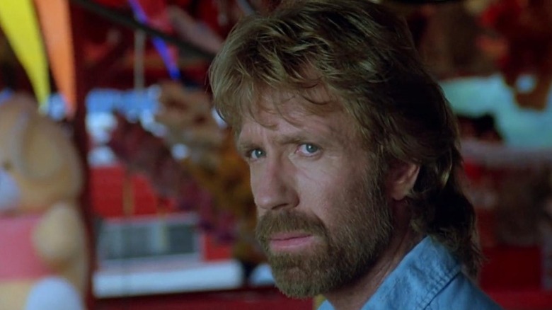 Chuck Norris as Hunter looking on in Invasion USA