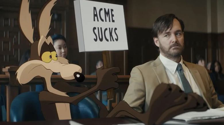 Wile E. Coyote holding up "Acme Sucks" sign in Coyote vs ACME