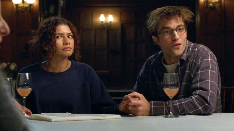 Emma (Zendaya) and Charlie (Robert Pattinson) sitting at a table in The Drama