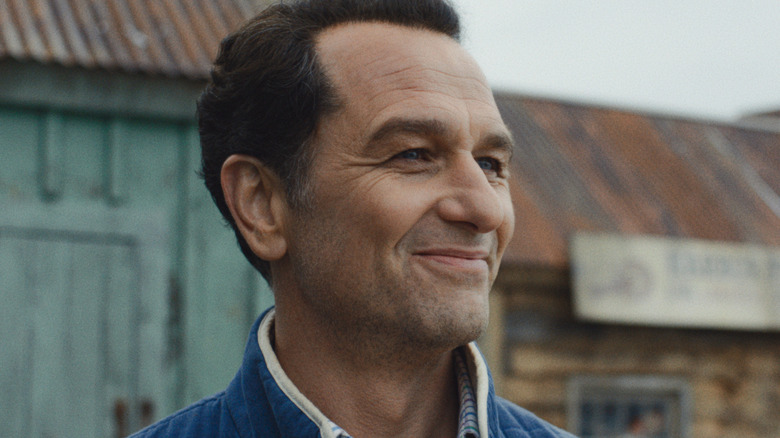 Tom smiling and looking into the distance in Widow's Bay