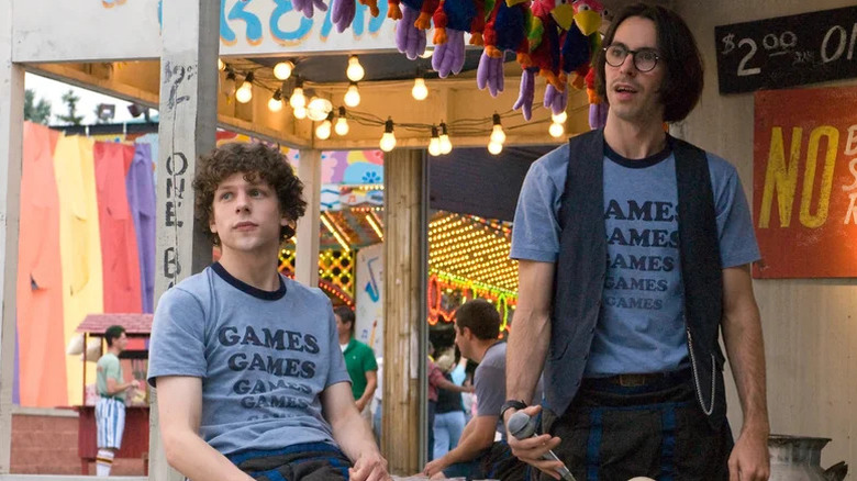 James Brennan (Jesse Eisenberg) and Joel (Martin Starr) hang out next to a theme park attraction in Adventureland