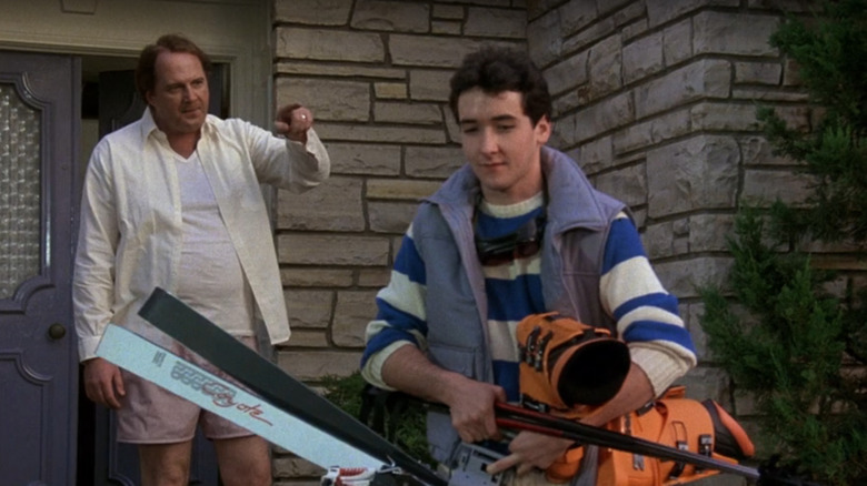 Al Meyer (David Ogden Stiers) points at Lane Meyer (John Cusack) while he carries sports equipment in Better Off Dead (1985)